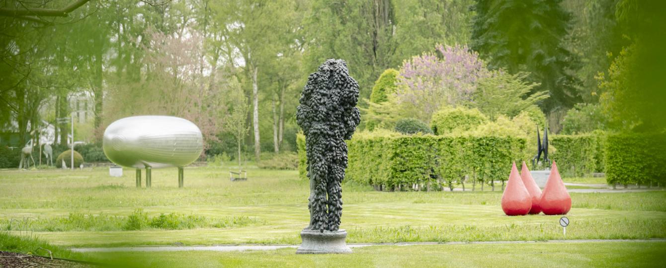 Zicht vanuit gebladerte op Hortiflora met kunstwerk van Deacon, Creten en Visch